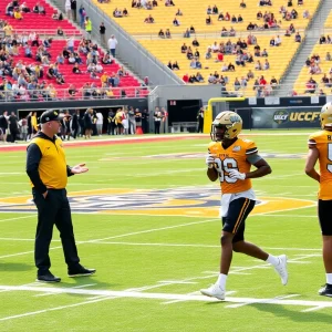 Athletes practicing on a university football field.