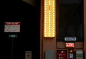 Exterior of the Renaissance Theatre with safety violation notices.